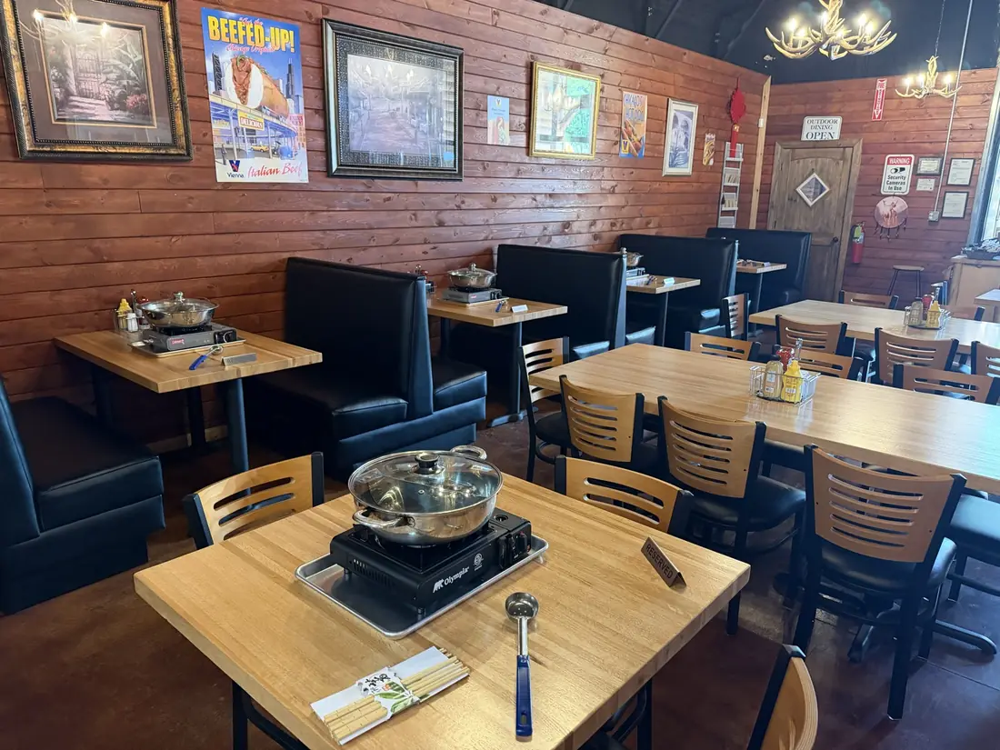 Medicine Bow Farms dining room with wooden tables, booths and antler chandeliers.