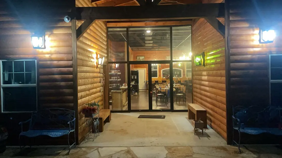 The Medicine Bow Farms entrance lit up after dark.